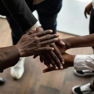 MULTIPLE PERSONS SHAKING HANDS WITH EACH OTHER